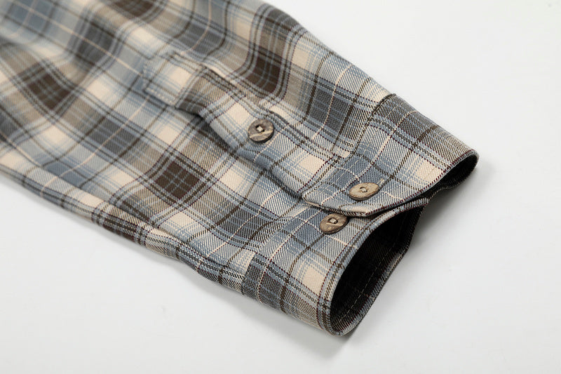 Plaid shirt with a button on a light gray background