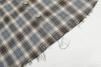 Plaid fabric with a frayed edge on a white background